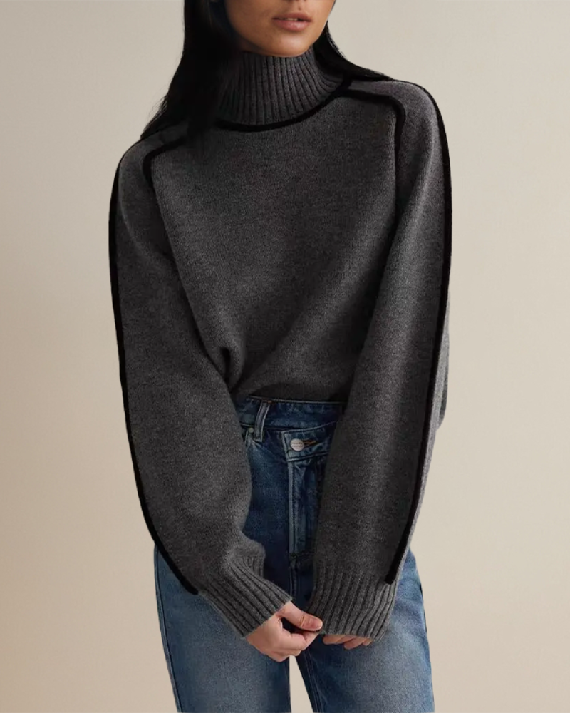 Merel grijze colsweater met contrastbies, close-up
