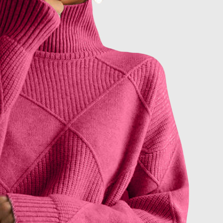 Close-up van kraag en geometrisch patroon in roze coltrui